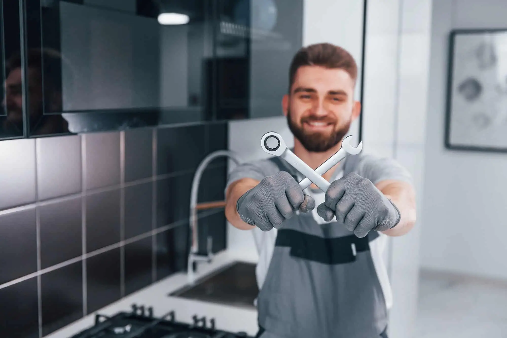 Professional licensed plumber performing emergency residential plumbing repairs