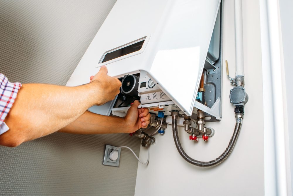 Experienced technicians completing a high-efficiency boiler system replacement and calibration