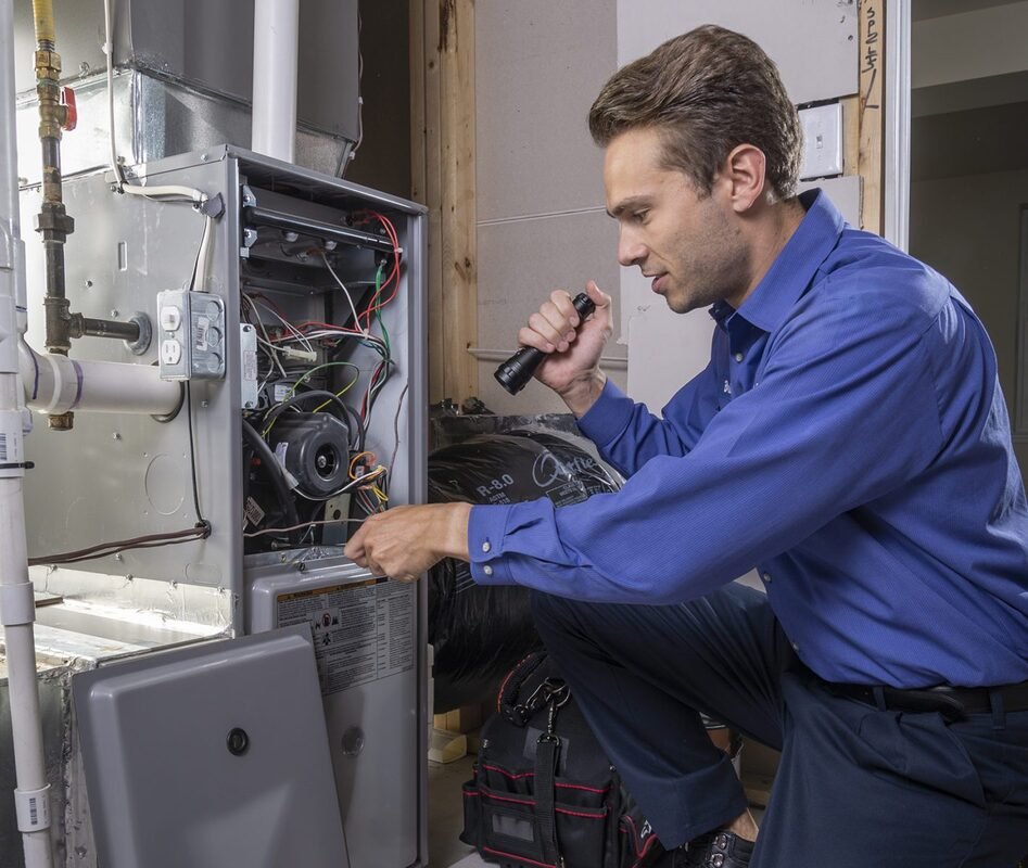 Certified HVAC technician installing a new energy-efficient central heating furnace